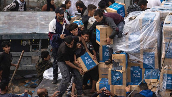 2023年12月17日，巴勒斯坦難民在拉法攔截一輛進入加薩地帶的人道救援主義卡車。（照片來源：AP Photo/Fatima Shbair）